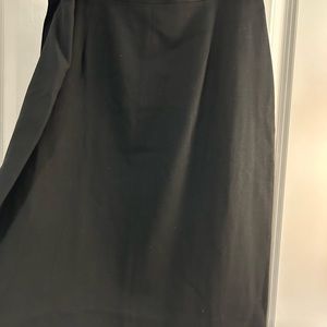 Ladies black knee length bi fold skirt lined with three front side pleats